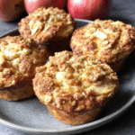 Apple pumpkin streusel muffins are displayed as a delicious fall baking treat with a golden-brown streusel topping.