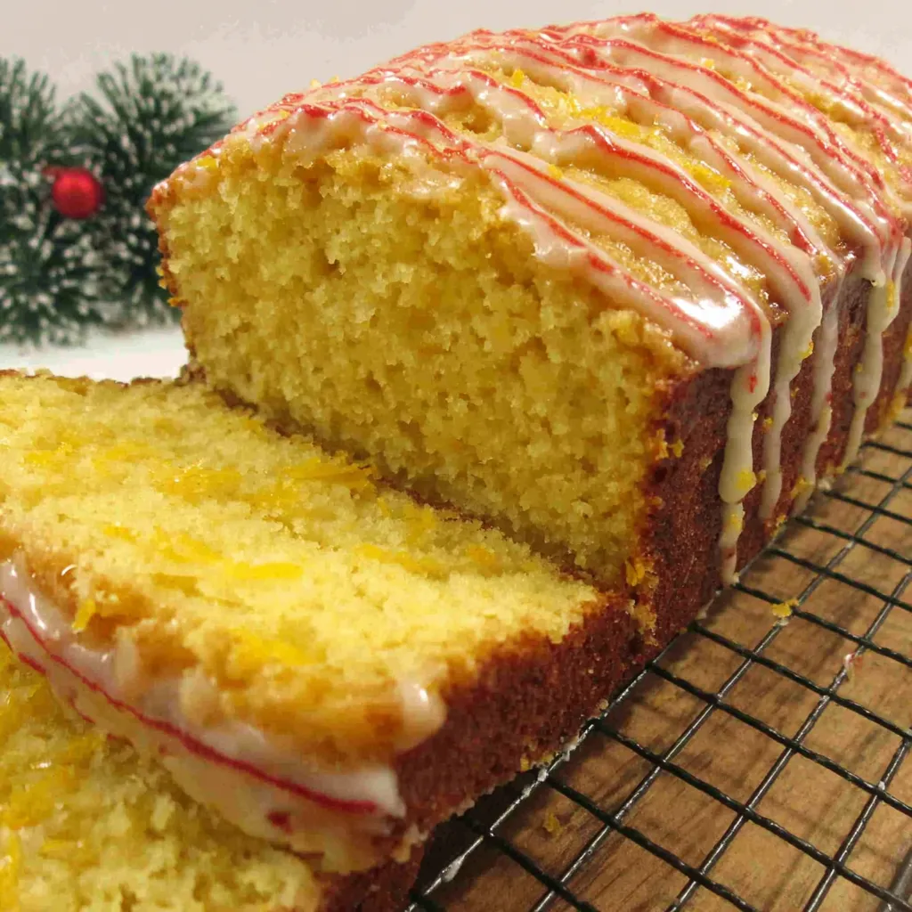 Close-up of a festive loaf of Christmas Eggnog Bread, showcasing its golden crust and sprinkle of nutmeg.