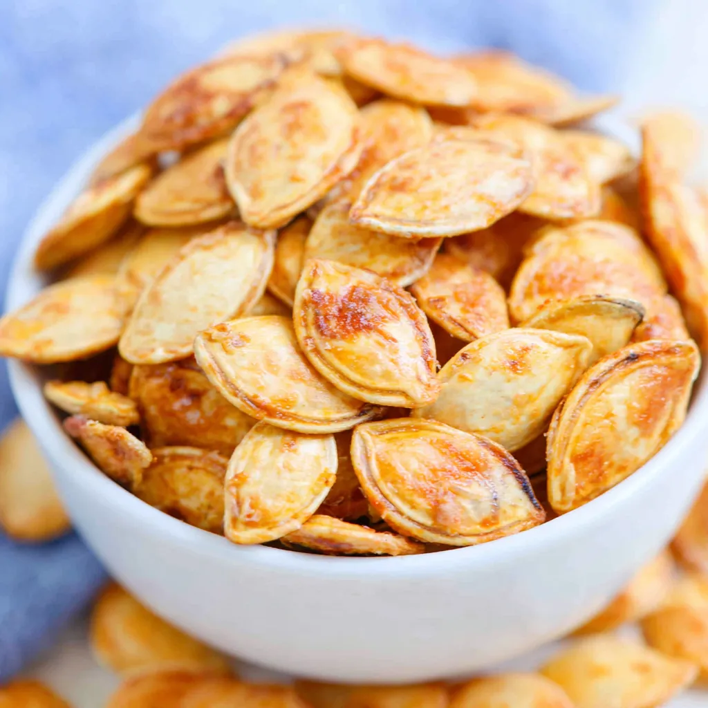 Close-up of golden Garlic Roasted Pumpkin Seeds, showcasing their texture and delicious seasoning.