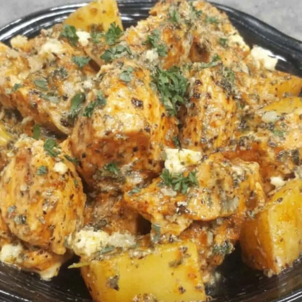 Close-up shot of Creamy Garlic Parmesan Crockpot Chicken & Potatoes, showcasing the creamy sauce and tender chicken.