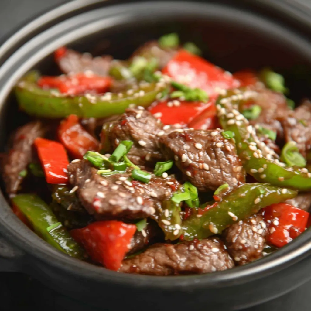 Close-up view of a prepared Pepper Steak Crock Pot dish, ready to be served.