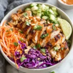 A vibrant and delicious Bang Bang Chicken Bowl is showcased as the featured image for the recipe.