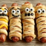 A featured image showcasing spooky and delicious Hot Dog Mummies, perfect for a Halloween party.