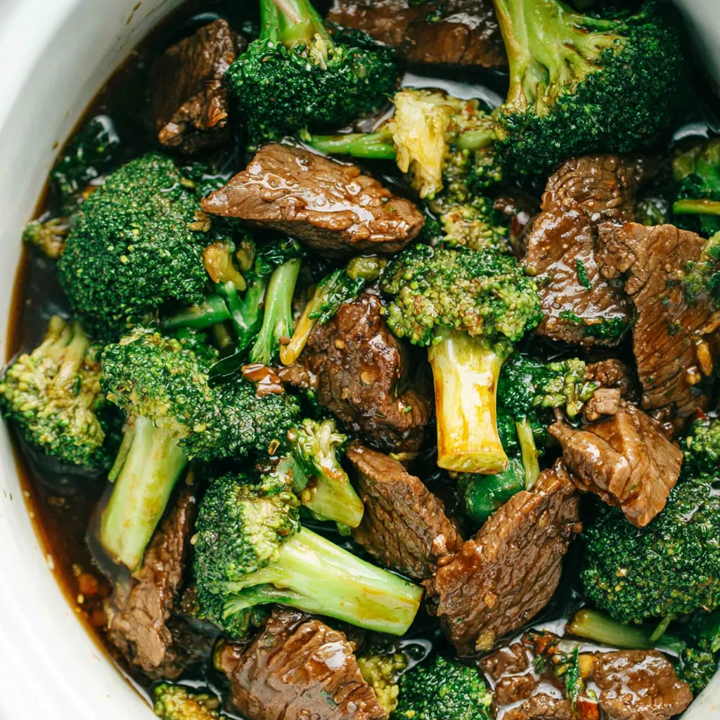 Easy slow cooker beef and broccoli simmers to tender perfection in this delicious and flavorful featured image.