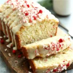 A festive loaf of Christmas Eggnog Bread sits ready to be sliced and enjoyed during the holidays.