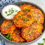 Golden-brown sweet potato hash browns are piled high in a cast iron skillet, showcasing a delicious and healthy breakfast or side dish option.