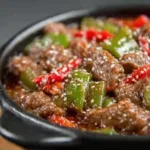 Delicious Pepper Steak Crock Pot simmering in a slow cooker, ready to be served.