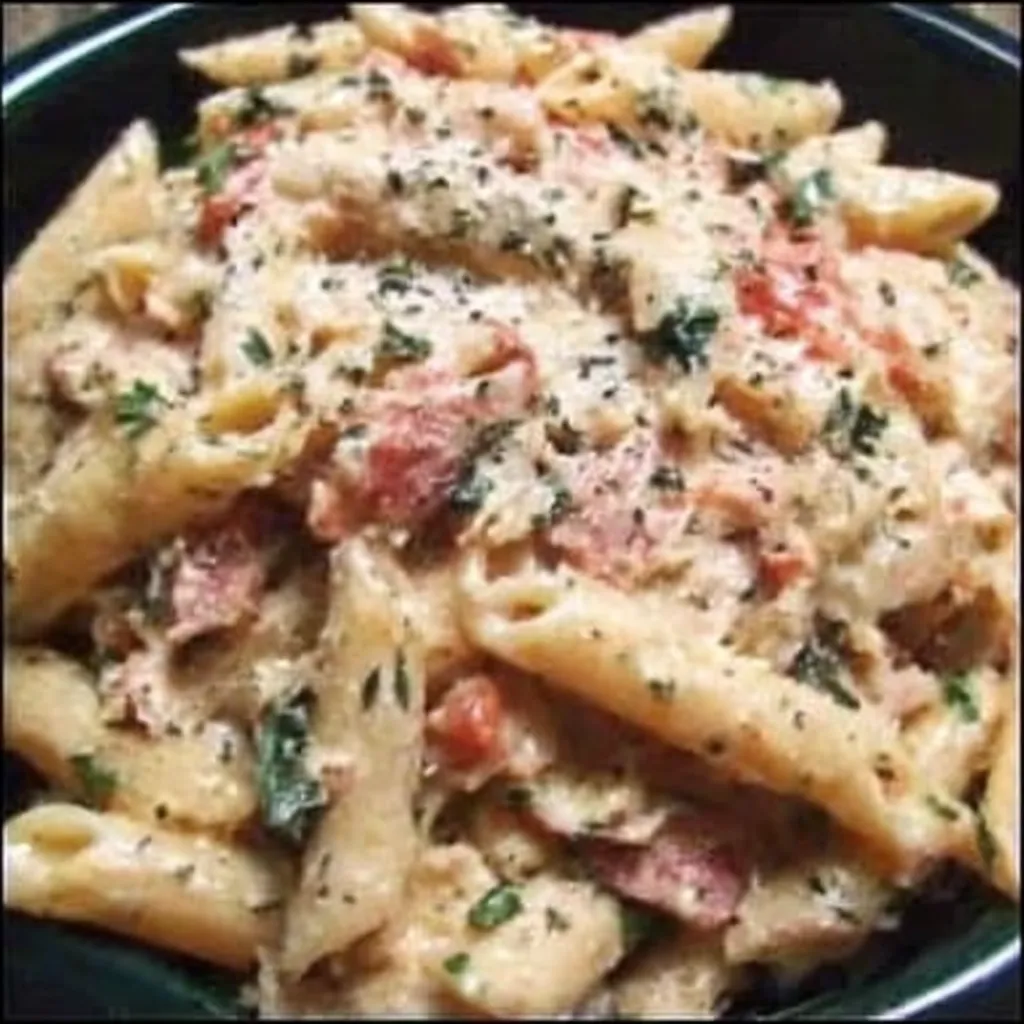 Slow Cooker Creamy Tuscan Pasta featured in a delicious and easy recipe article.