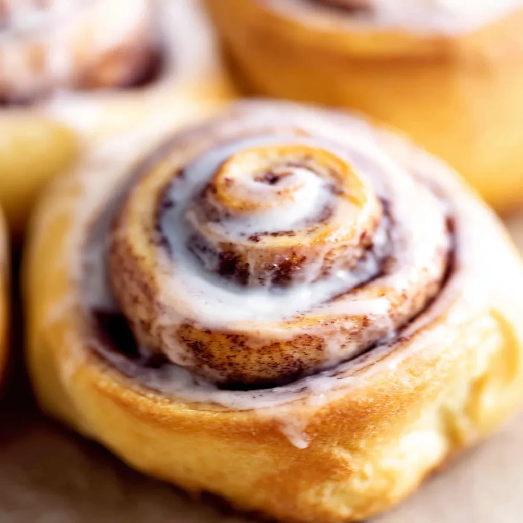 Close-up view of freshly baked Apple Cinnamon Rolls, showcasing their soft texture and apple filling.