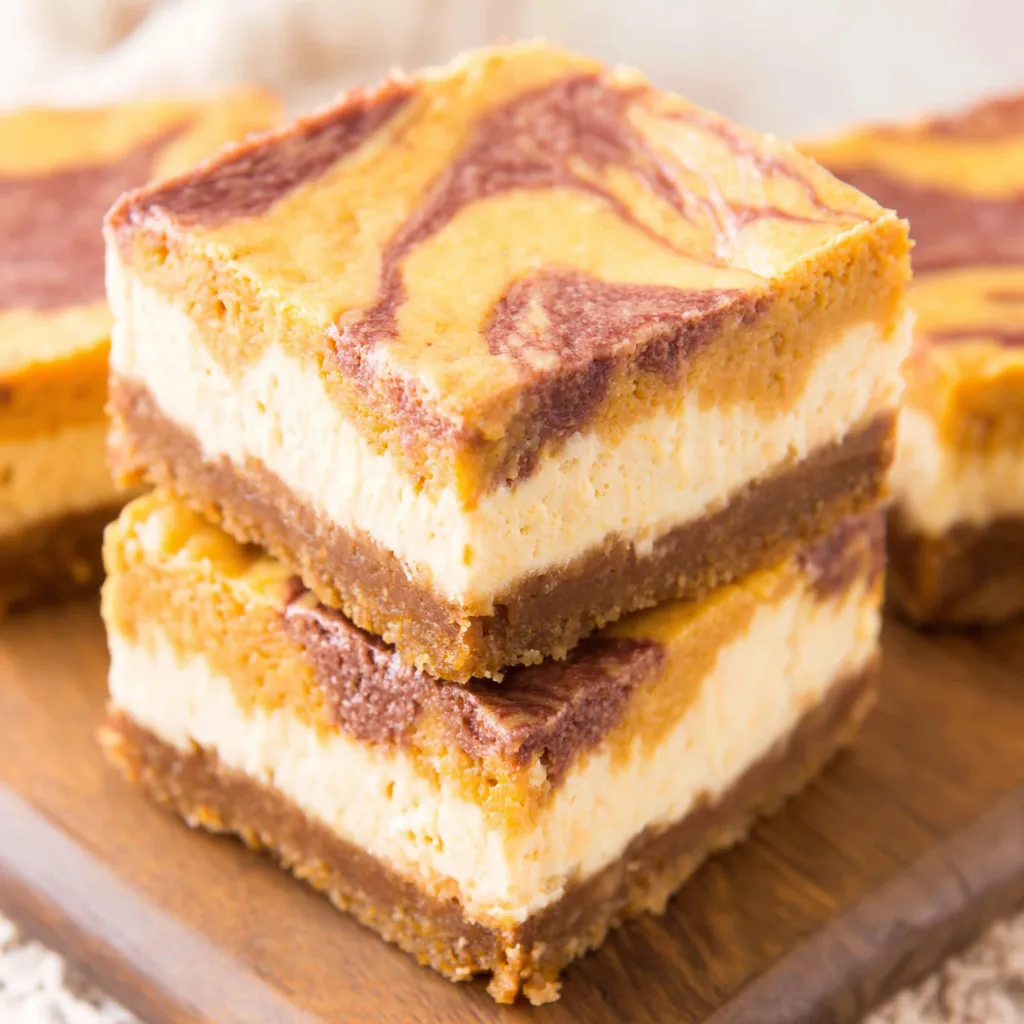 Pumpkin Spice Cheesecake Bars Recipe Close-up view of delicious Pumpkin Spice Cheesecake Bars, perfect for fall baking.
