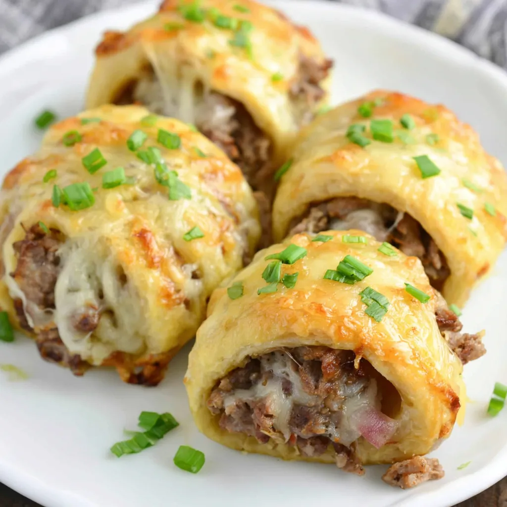 Keto Philly Cheesesteak Rolls Recipe Close-up of delicious Keto Philly Cheesesteak Rolls with melted cheese and thinly sliced steak, showcasing their appetizing texture.