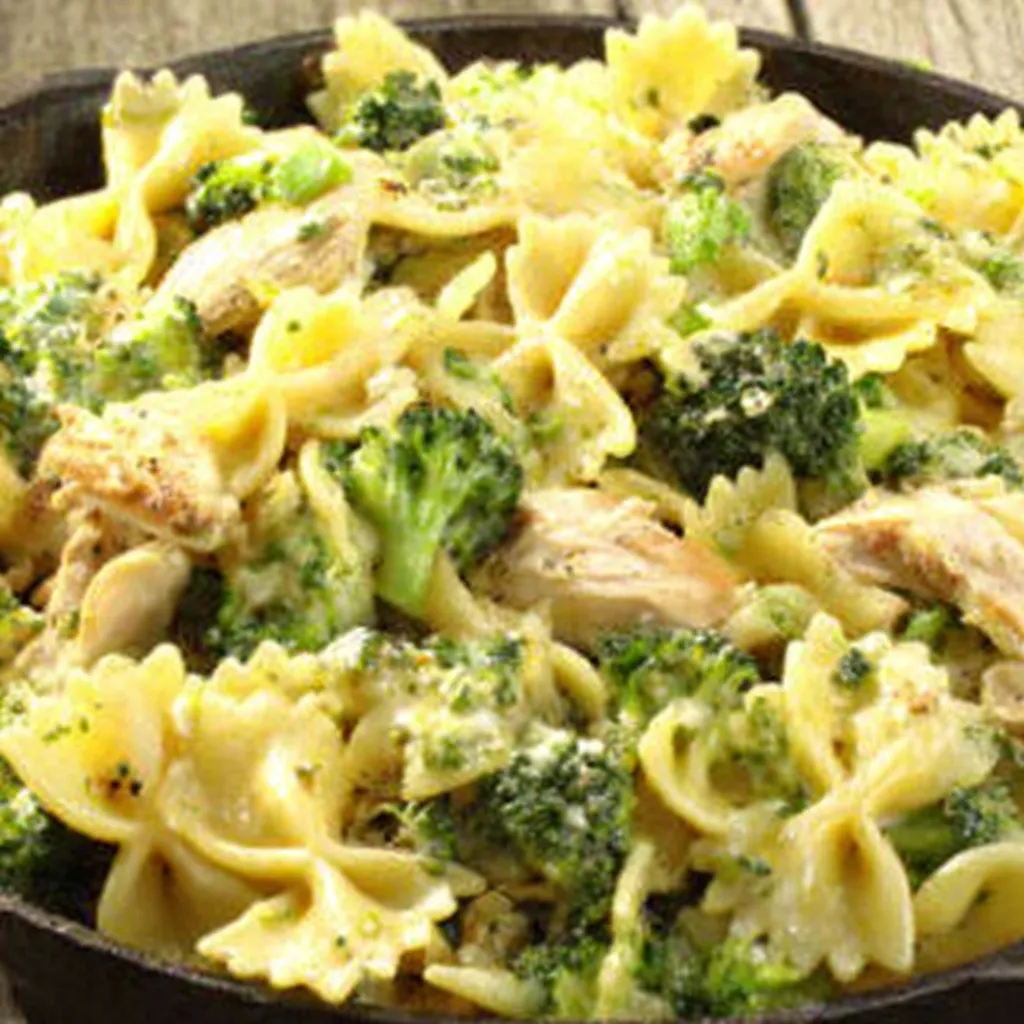 Close-up shot of creamy Rotisserie Chicken Broccoli Pasta in a bowl, showcasing the tender chicken and bright green broccoli.