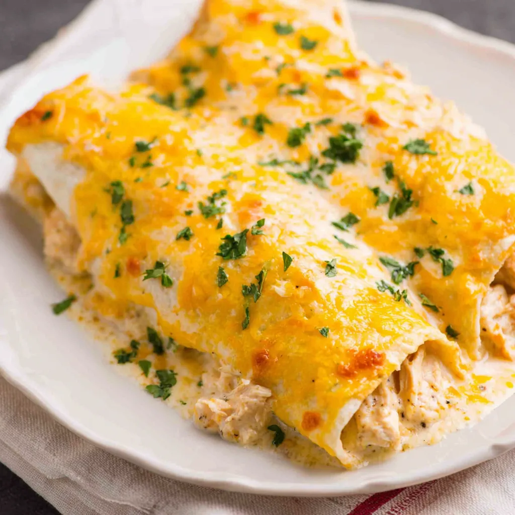 Creamy White Chicken Enchiladas, a delicious and comforting Mexican-inspired dish, are shown in this featured image.