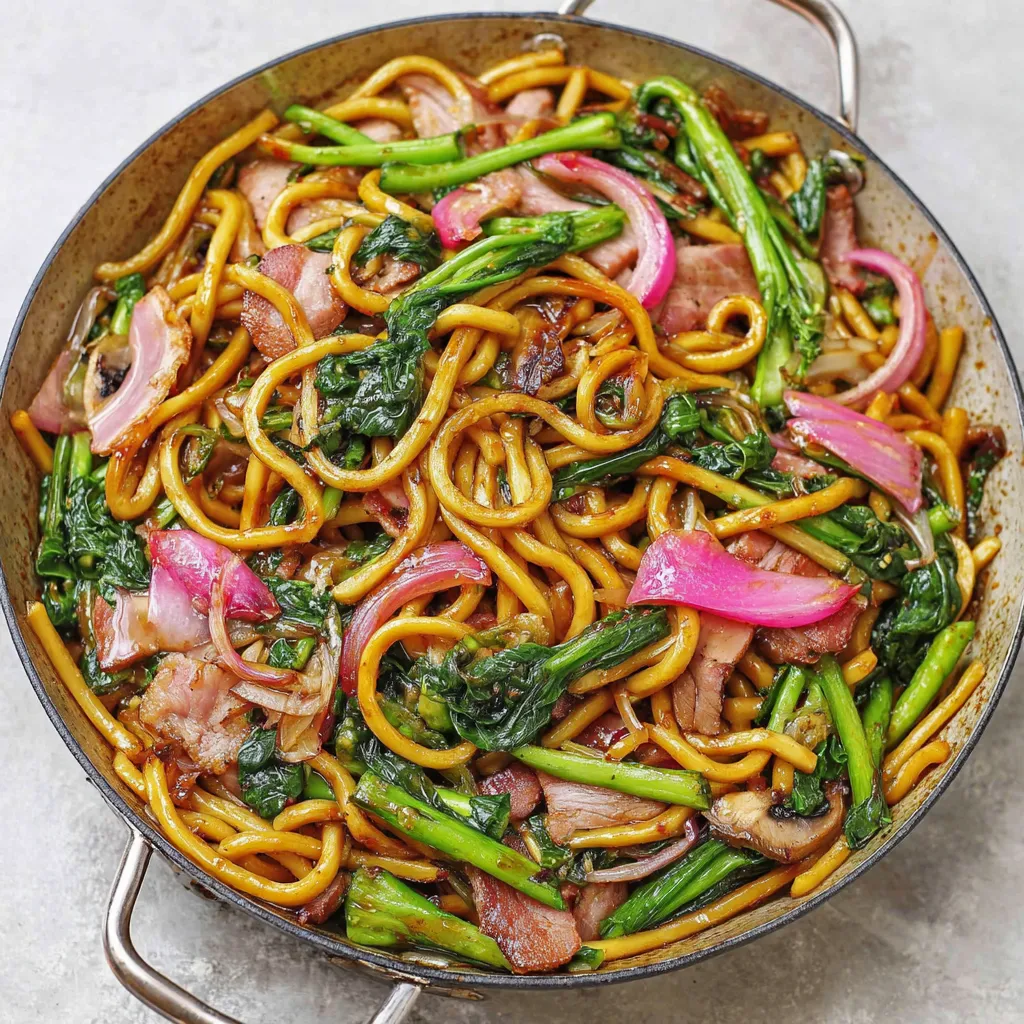 Delicious plate of Yaki Udon noodles with vegetables and meat, ready to eat.