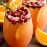 Festive Christmas Morning Punch garnished with cranberries and rosemary sprigs, ready to be served as a holiday brunch beverage.