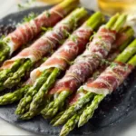 Asparagus Wrapped In Prosciutto spears are beautifully displayed in this featured image, showcasing a delicious and elegant appetizer.